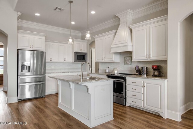 kitchen with white cabinetry, stainless steel appliances, a center island with sink, custom range hood, and dark hardwood / wood-style floors