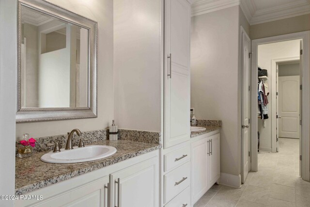 bathroom featuring vanity, crown molding, and tile patterned floors