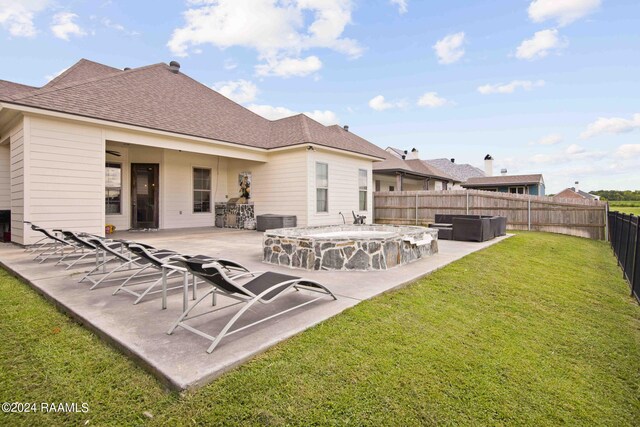 back of house featuring a patio and a yard