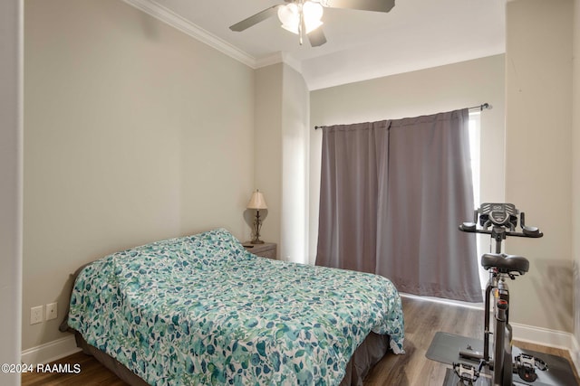 bedroom with hardwood / wood-style flooring, ornamental molding, and ceiling fan