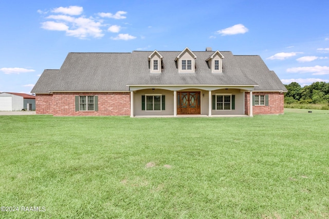 new england style home featuring a front lawn