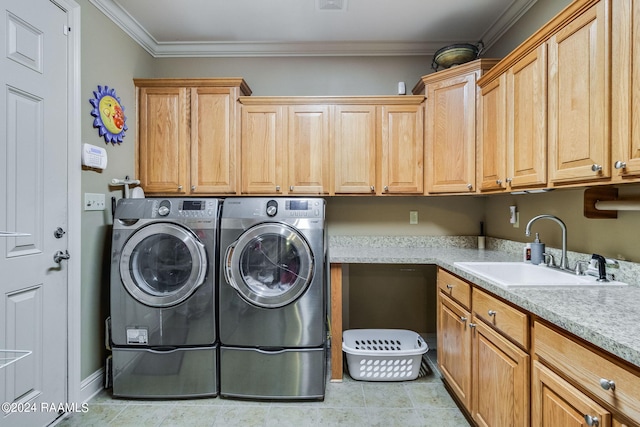 clothes washing area featuring sink, crown molding, cabinets, light tile patterned floors, and independent washer and dryer