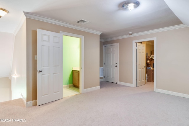 unfurnished bedroom featuring crown molding, light carpet, and ensuite bathroom