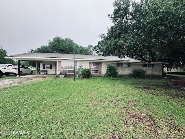 ranch-style home with a front yard and a carport