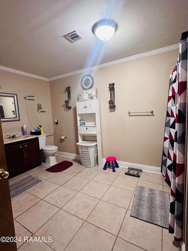 bathroom with tile floors, crown molding, toilet, and vanity