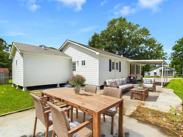 back of house with outdoor lounge area, a patio, and a yard