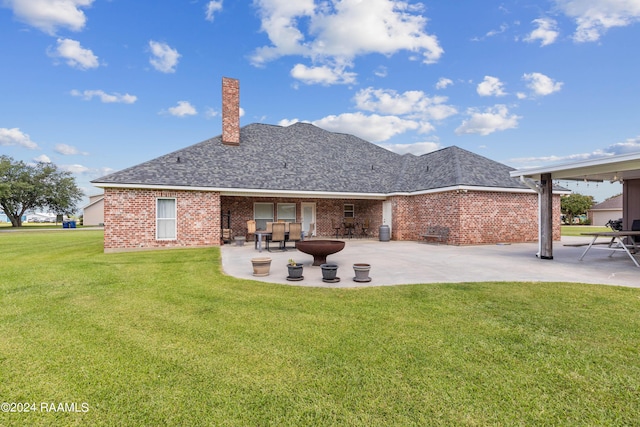 back of house with a lawn and a patio area