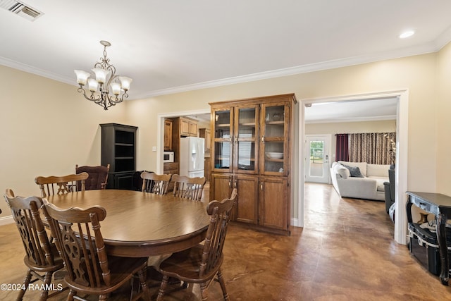 dining room featuring crown molding and a chandelier