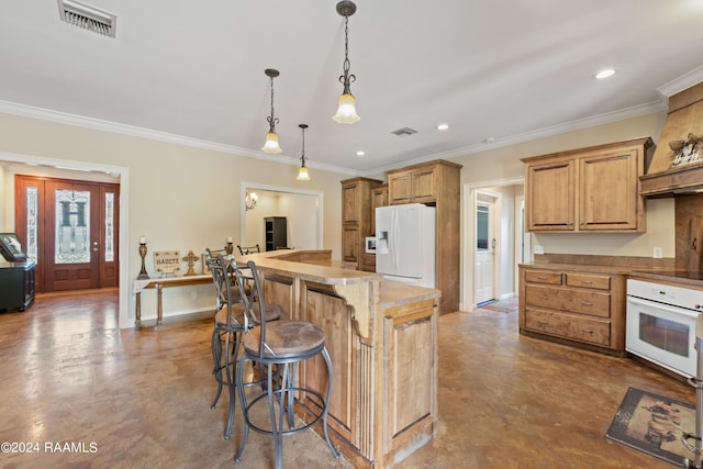 kitchen with white appliances, hanging light fixtures, a kitchen bar, and crown molding