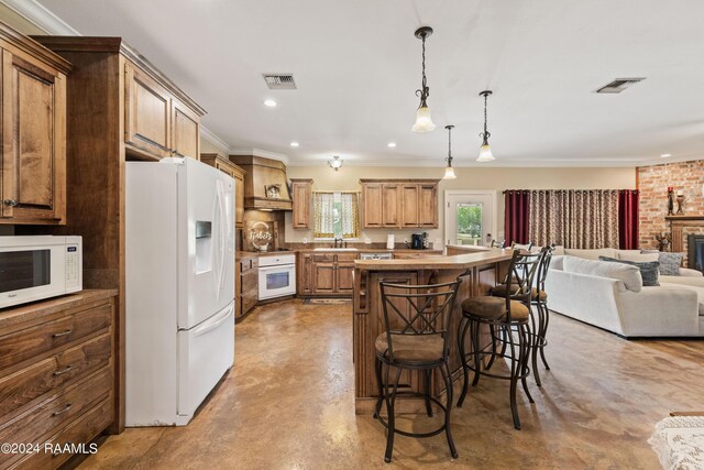 kitchen featuring white appliances, a breakfast bar area, a center island, custom range hood, and sink