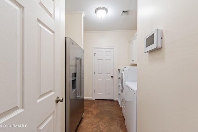 laundry room featuring cabinets, crown molding, and washer and clothes dryer