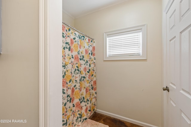 bathroom with a shower with shower curtain and crown molding