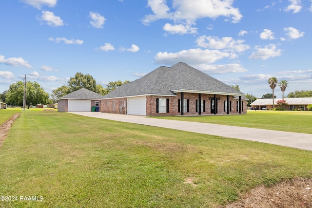 view of front of property with a front yard and a garage