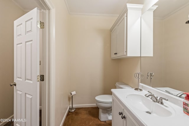 bathroom with toilet, vanity, and ornamental molding