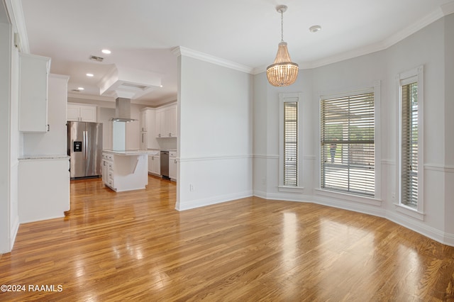 unfurnished living room featuring light hardwood / wood-style floors, a notable chandelier, and ornamental molding