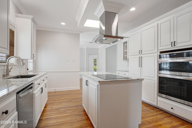 kitchen featuring island range hood, white cabinets, a kitchen island, light stone counters, and stainless steel appliances