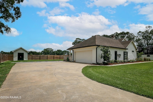 view of front of property featuring a front yard and a garage