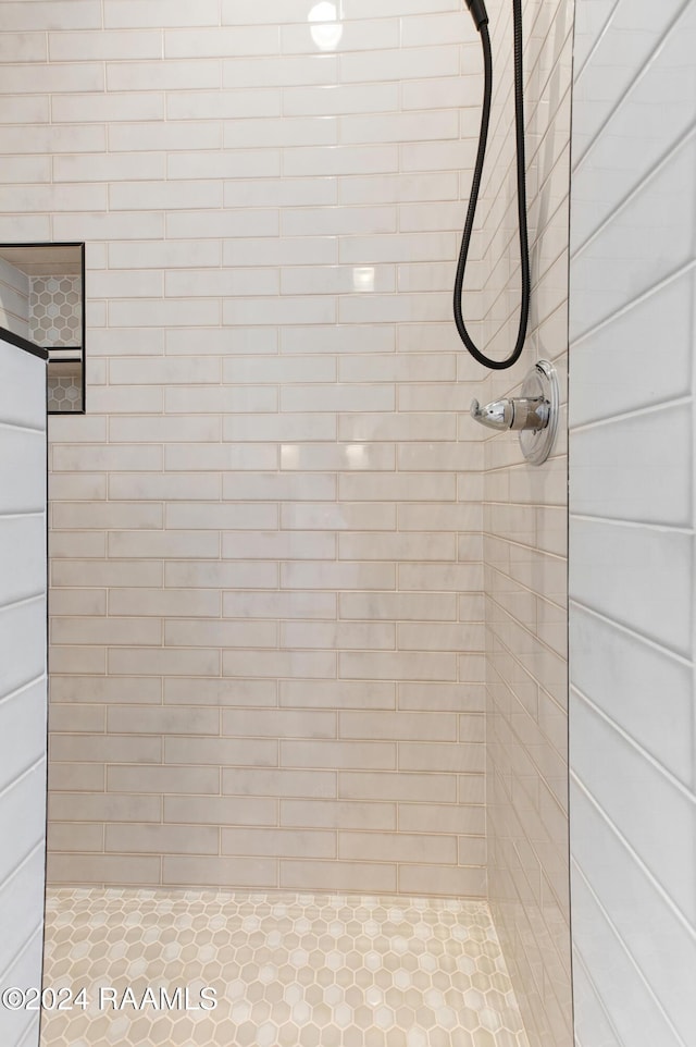 bathroom with tiled shower