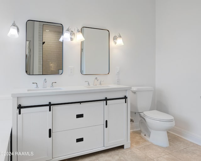 bathroom with tile patterned floors, vanity, toilet, and walk in shower