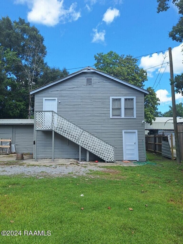 1225 W S St, Opelousas, LA 70570 - rear view of property featuring a lawn