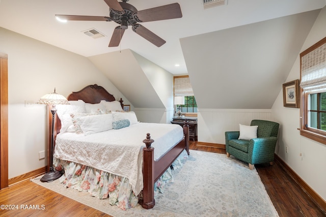 bedroom featuring visible vents, wood finished floors, vaulted ceiling, and a ceiling fan