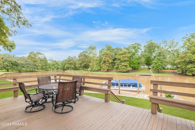 wooden deck featuring a water view and outdoor dining area