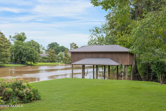 dock area featuring a water view and a yard