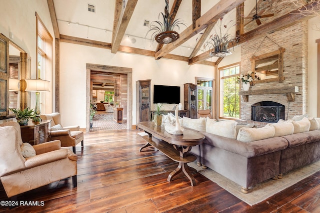 living area with high vaulted ceiling, visible vents, a brick fireplace, beam ceiling, and dark wood finished floors