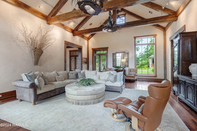 living room with a notable chandelier, high vaulted ceiling, beam ceiling, and dark wood-style flooring