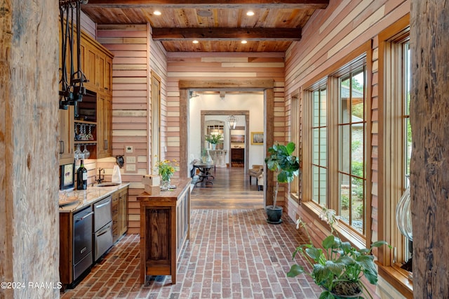 bar featuring wood walls, recessed lighting, wooden ceiling, beam ceiling, and brick floor