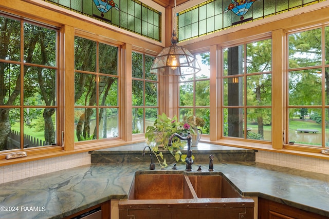 sunroom / solarium with a sink