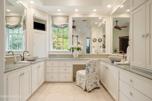 bathroom featuring ceiling fan, vanity, and a healthy amount of sunlight