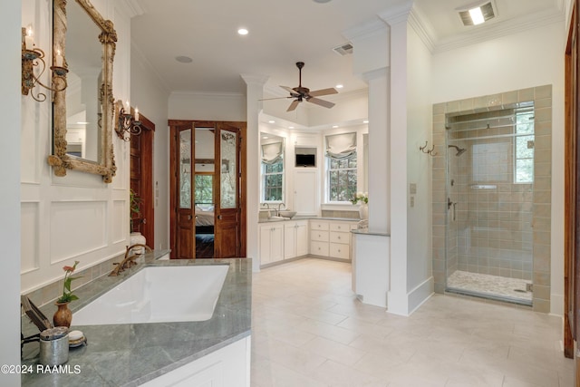 ensuite bathroom featuring a stall shower, visible vents, ornamental molding, and a sink