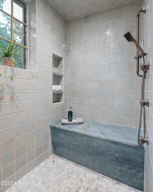 bathroom with a tile shower