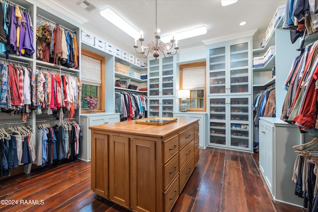 spacious closet featuring dark wood-type flooring, a chandelier, and visible vents