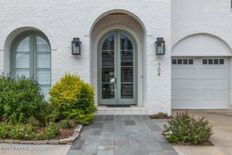 property entrance with french doors and a garage