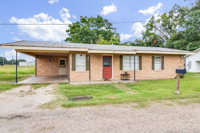 single story home with a front yard and a carport