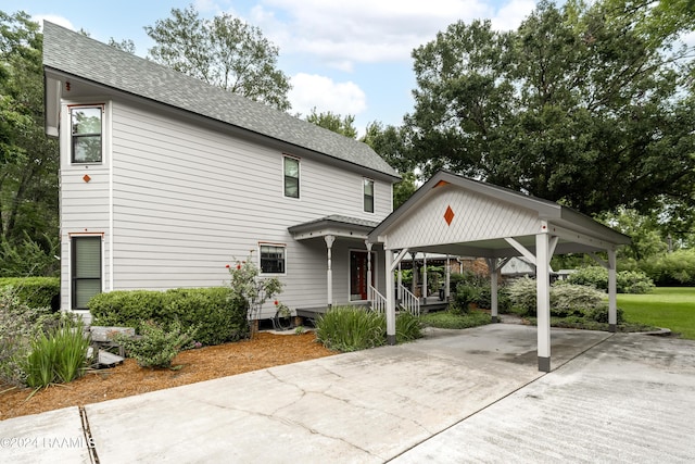 319 Goodwin St, Welsh, LA 70591 - view of front of home with concrete driveway, a carport, and roof with shingles