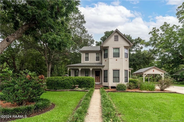 319 Goodwin St, Welsh, LA 70591 - victorian-style house featuring a front lawn, covered porch, roof with shingles, and a gazebo