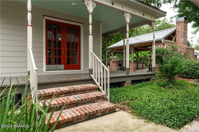 319 Goodwin St, Welsh, LA 70591 - doorway to property featuring covered porch and a chimney