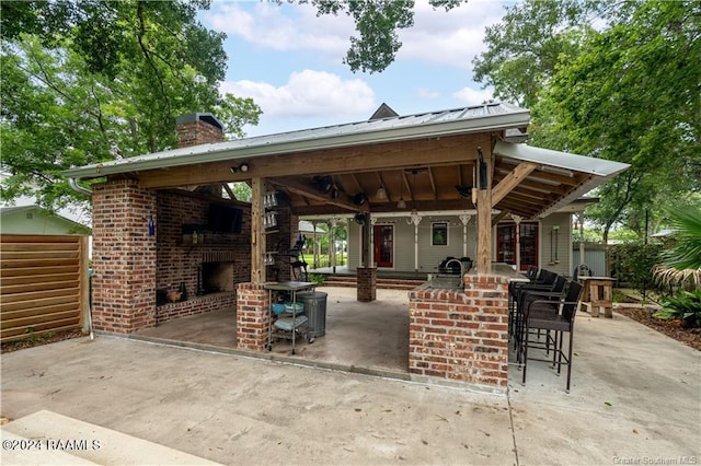 319 Goodwin St, Welsh, LA 70591 - view of patio featuring an outdoor brick fireplace