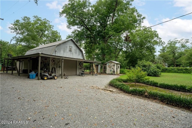 319 Goodwin St, Welsh, LA 70591 - view of front of property featuring an outbuilding, a gambrel roof, and gravel driveway
