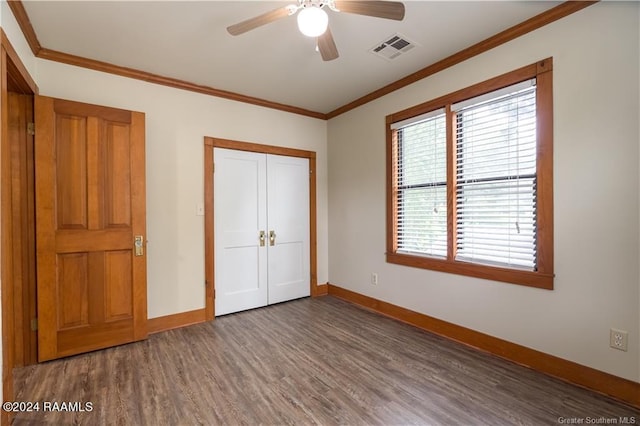 319 Goodwin St, Welsh, LA 70591 - unfurnished bedroom with wood finished floors, multiple windows, crown molding, a closet, and a ceiling fan