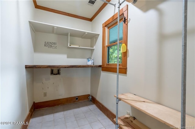 319 Goodwin St, Welsh, LA 70591 - laundry room with hookup for a washing machine, ornamental molding, and light tile patterned floors