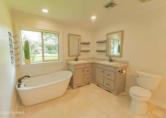 bathroom with ornamental molding, a tub, vanity, and tile patterned floors