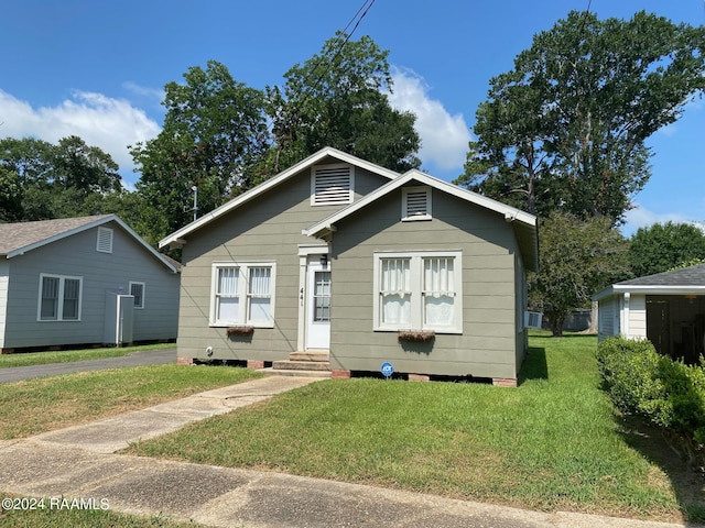 bungalow-style house with a front yard