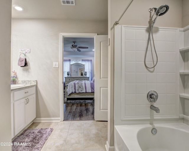 bathroom featuring vanity, tile patterned floors, tiled shower / bath, and ceiling fan