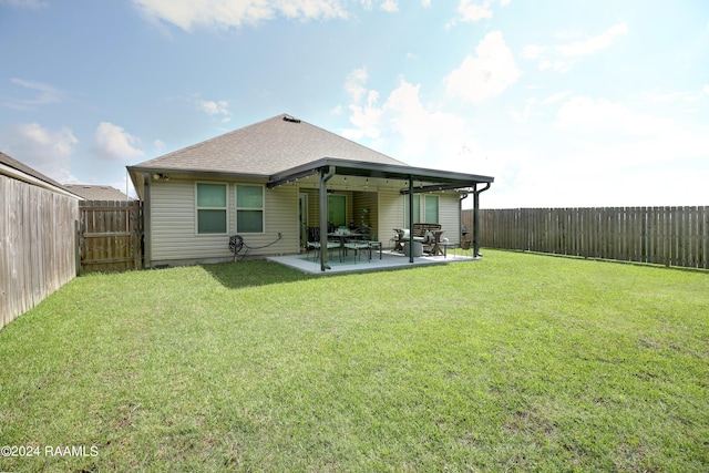 rear view of house featuring a patio area and a yard