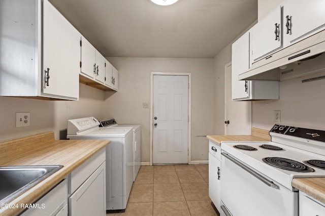 laundry area with separate washer and dryer and light tile patterned floors