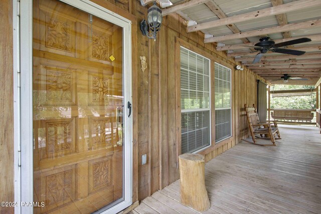 doorway to property featuring covered porch and ceiling fan